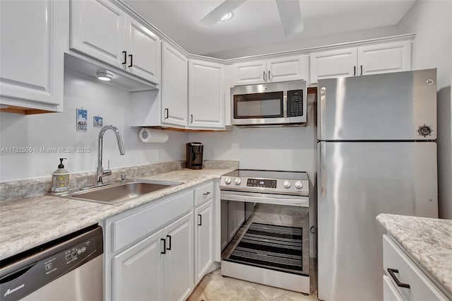 kitchen featuring white cabinetry, appliances with stainless steel finishes, sink, and ceiling fan