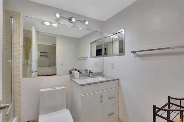 bathroom featuring vanity, an enclosed shower, and toilet