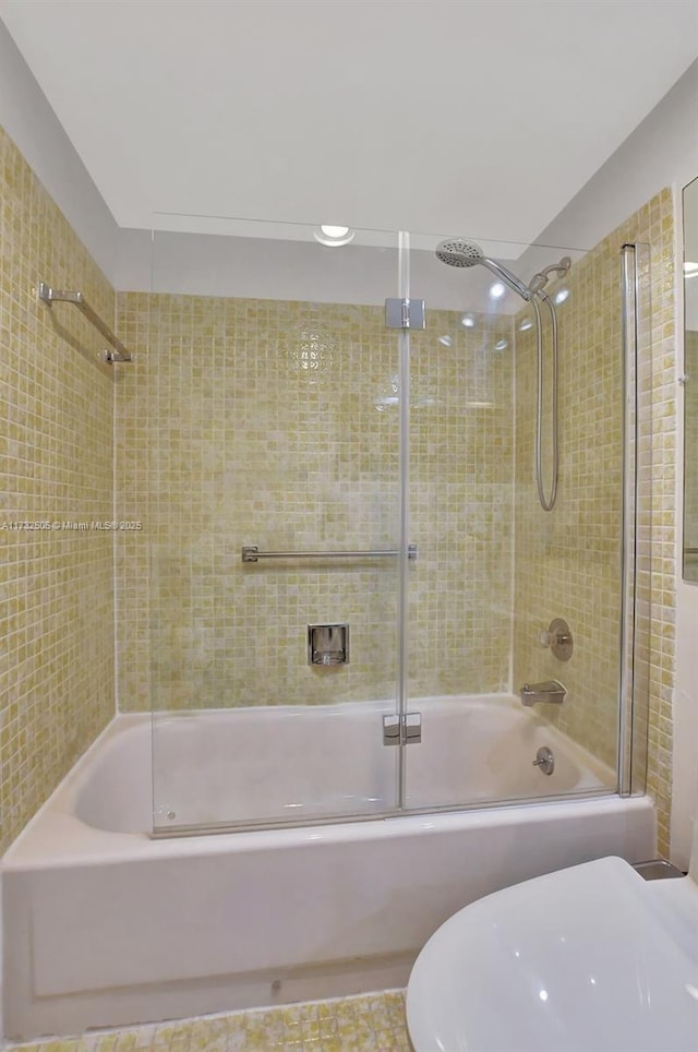 bathroom with shower / bath combination with glass door and toilet