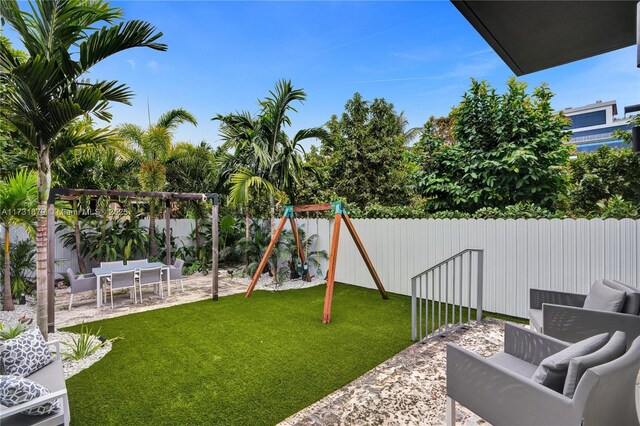 view of yard featuring a playground and a patio area