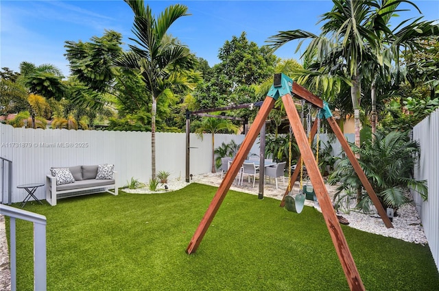 view of playground with a lawn