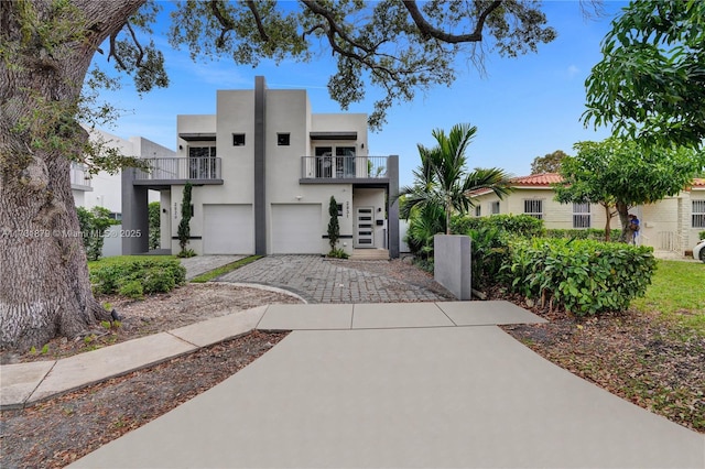 view of front of house featuring a balcony and a garage