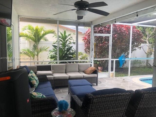 sunroom / solarium featuring ceiling fan