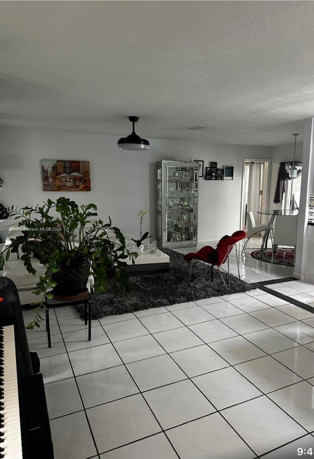 living room with light tile patterned floors and a textured ceiling