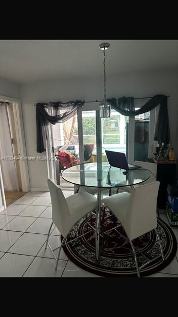 dining area featuring light tile patterned floors