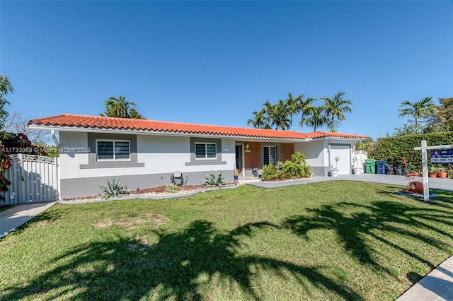 view of front of home featuring a garage and a front lawn