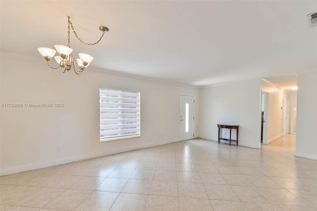 spare room featuring a chandelier, baseboards, light tile patterned floors, visible vents, and ornamental molding
