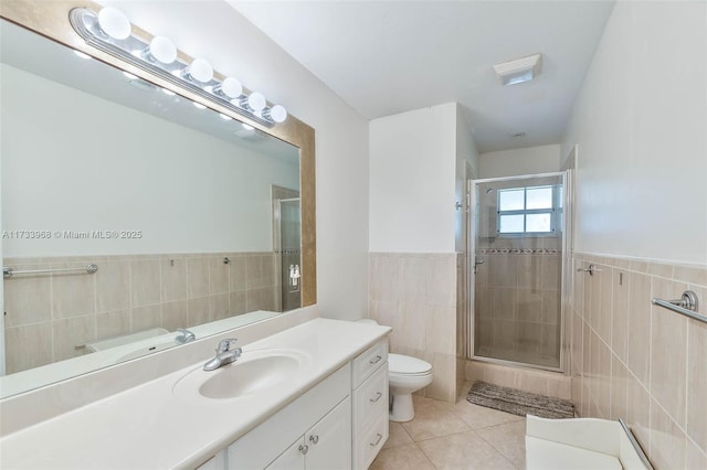 full bath with toilet, tile walls, a shower stall, and tile patterned flooring
