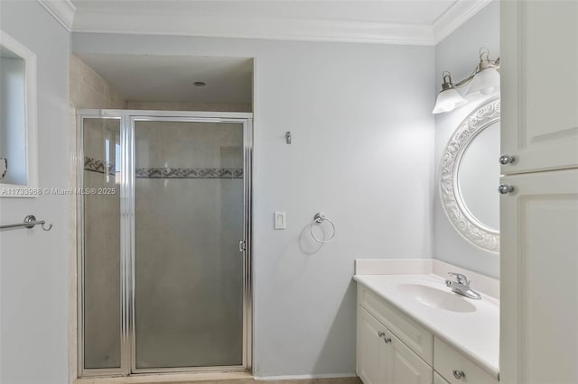bathroom with vanity, ornamental molding, and a shower stall