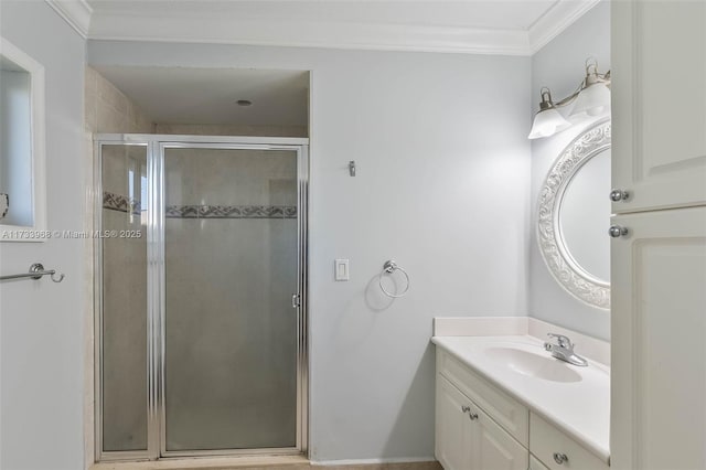 bathroom with vanity, an enclosed shower, and ornamental molding