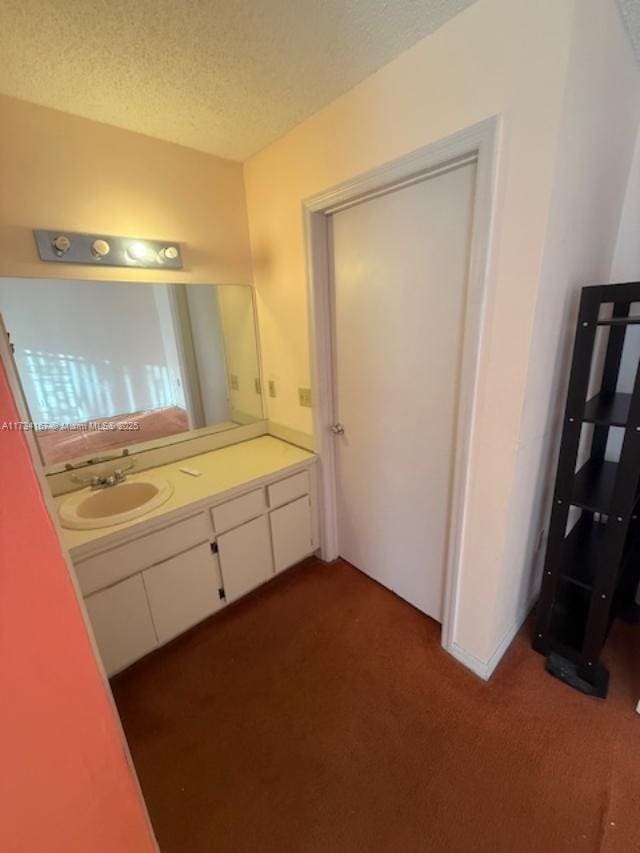 bathroom with vanity and a textured ceiling