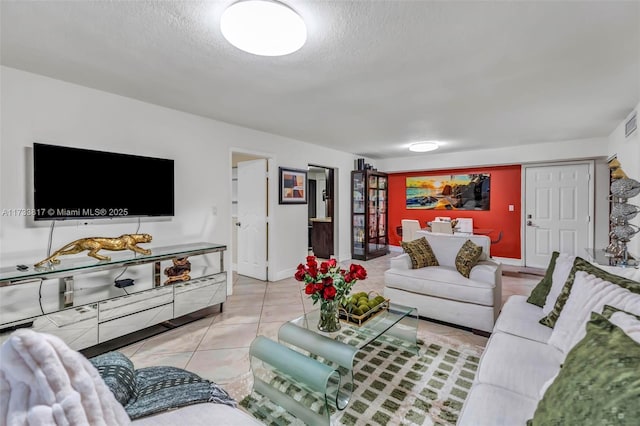 living room featuring a textured ceiling and light tile patterned flooring