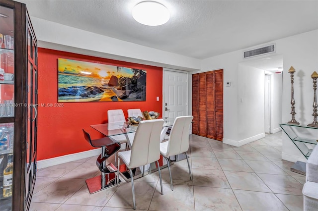 dining space featuring a textured ceiling