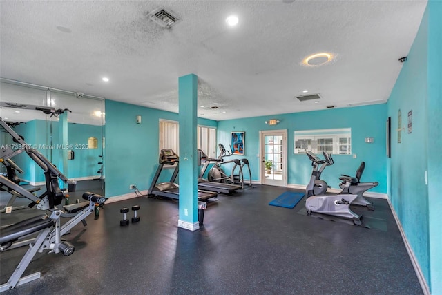 workout area with a textured ceiling