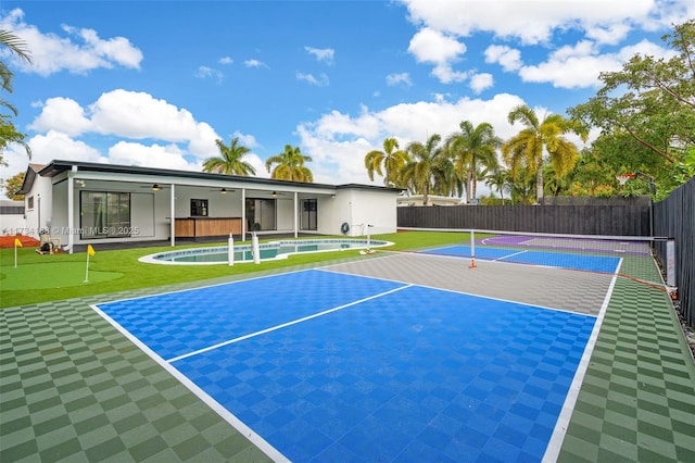 exterior space with a ceiling fan, fence, and basketball court