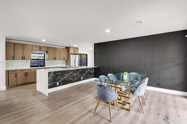 dining area featuring light wood-type flooring