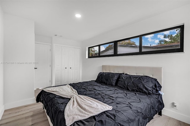 bedroom featuring light wood-type flooring and a closet