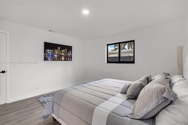 bedroom with hardwood / wood-style flooring