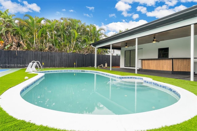 view of swimming pool featuring ceiling fan