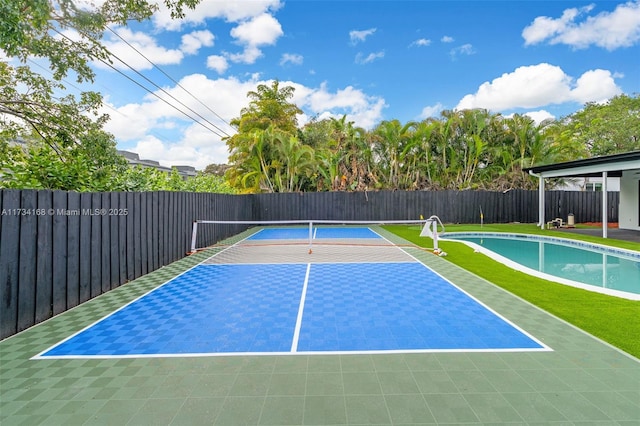 view of sport court with a fenced in pool