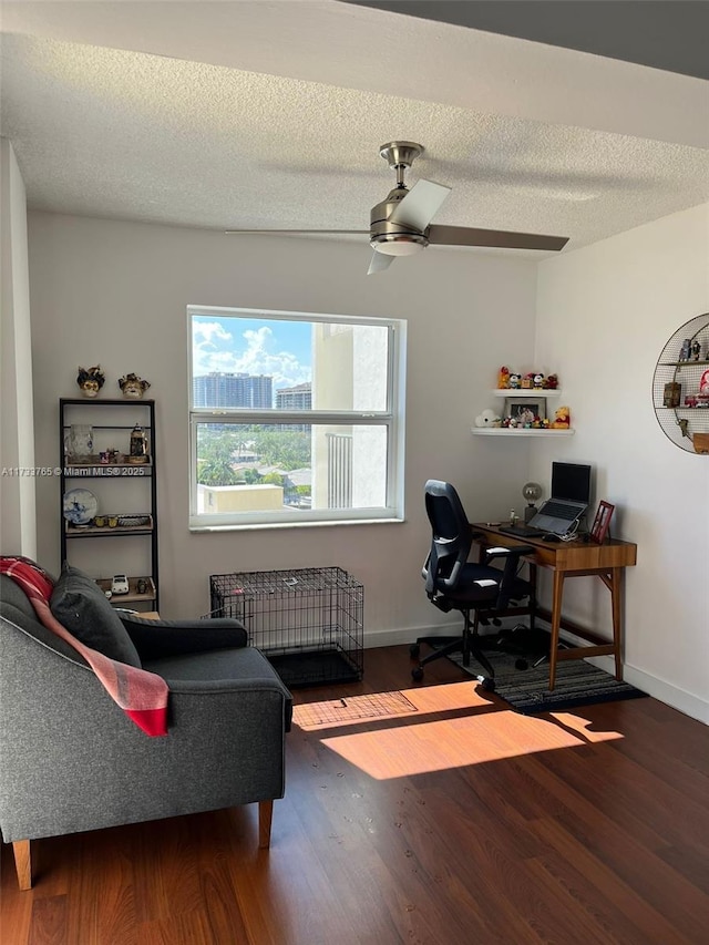 office area featuring ceiling fan, hardwood / wood-style floors, and a textured ceiling