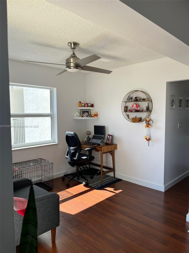 office area featuring ceiling fan, dark hardwood / wood-style floors, and a textured ceiling