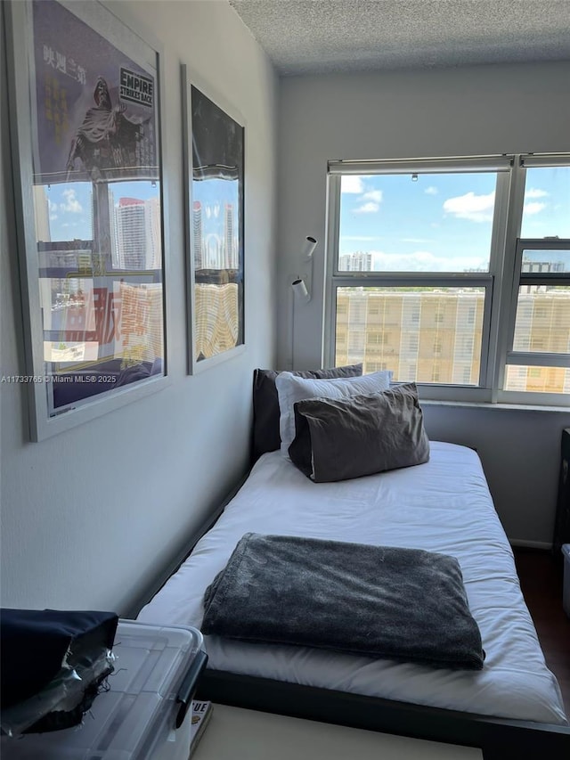 bedroom with multiple windows and a textured ceiling