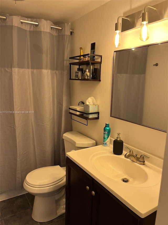 bathroom featuring tile patterned floors, vanity, and toilet