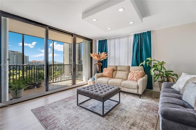 living room with floor to ceiling windows and hardwood / wood-style floors