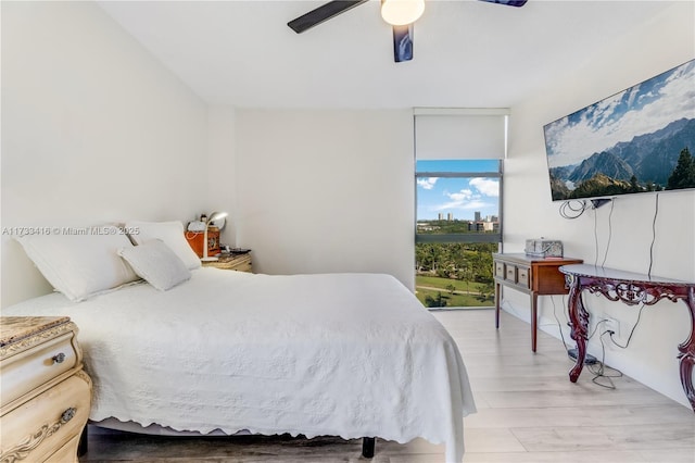 bedroom with light hardwood / wood-style flooring and ceiling fan