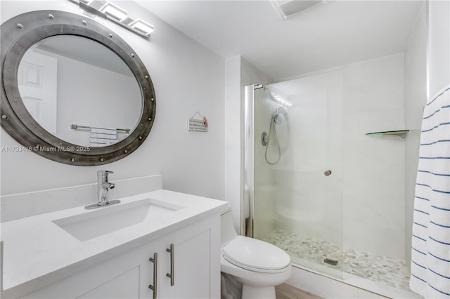 bathroom featuring vanity, toilet, and an enclosed shower