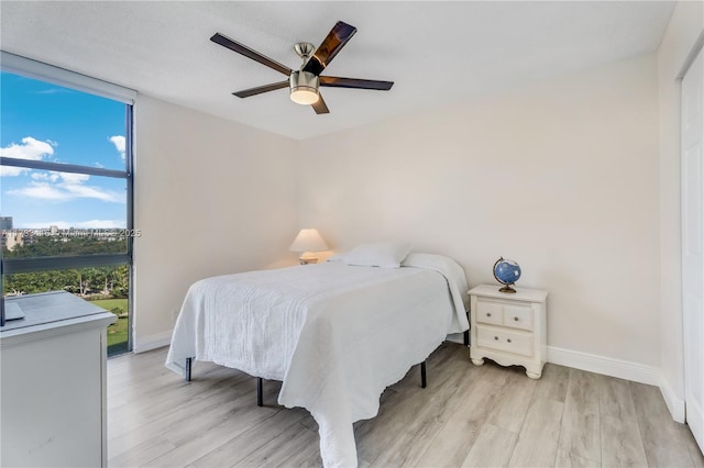 bedroom featuring ceiling fan and light hardwood / wood-style floors