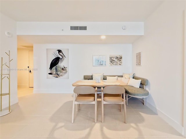 dining space featuring breakfast area, visible vents, baseboards, and tile patterned flooring