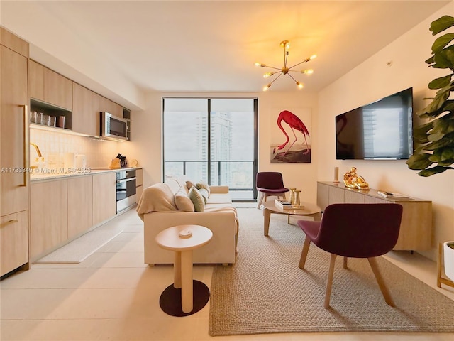 living area featuring a notable chandelier and a wall of windows