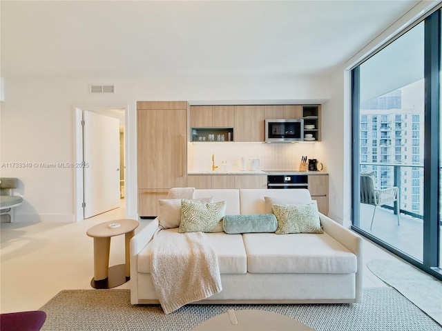 bedroom featuring visible vents and expansive windows