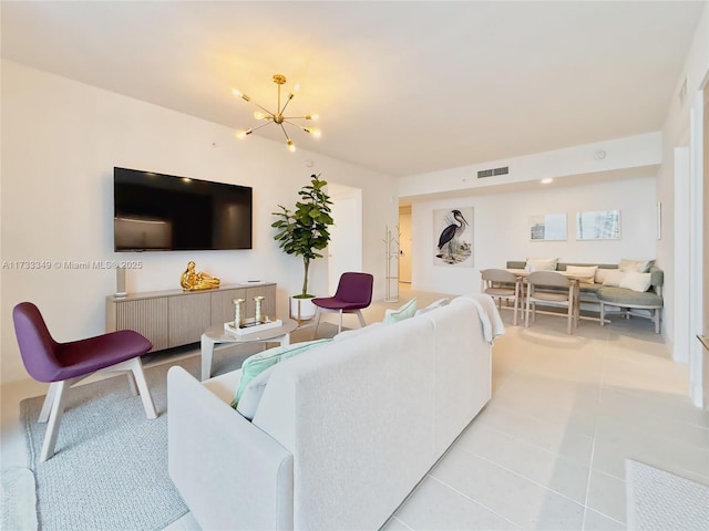 living area featuring light tile patterned floors, visible vents, and an inviting chandelier