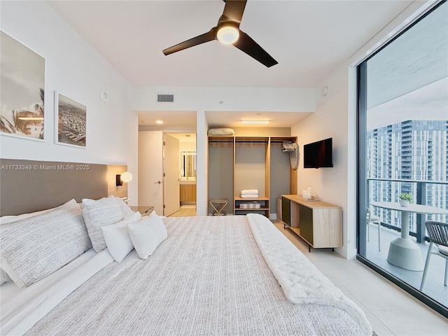 bedroom with ensuite bath, floor to ceiling windows, a ceiling fan, and a closet