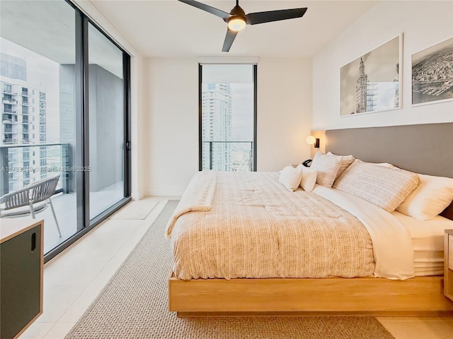 bedroom with a wall of windows, multiple windows, light tile patterned flooring, and a ceiling fan