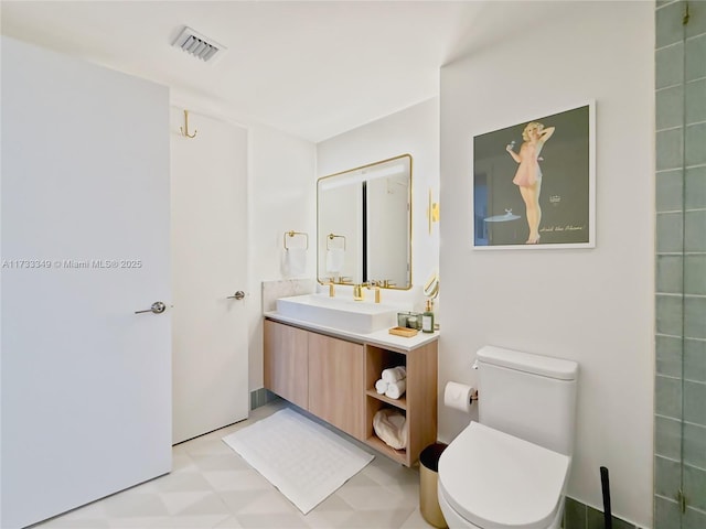 bathroom featuring tile patterned floors, visible vents, toilet, and vanity