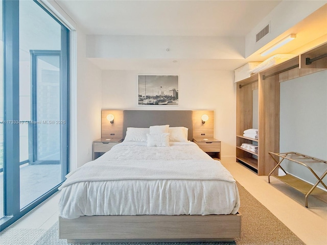 bedroom featuring visible vents, carpet floors, and expansive windows