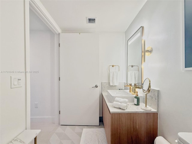 bathroom with tile patterned floors, visible vents, toilet, and vanity