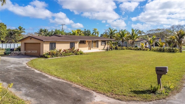 single story home featuring a garage and a front lawn