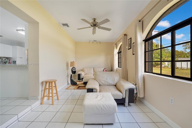 living room with light tile patterned floors and ceiling fan