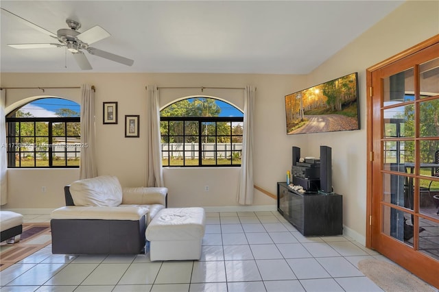 living area featuring light tile patterned flooring and ceiling fan