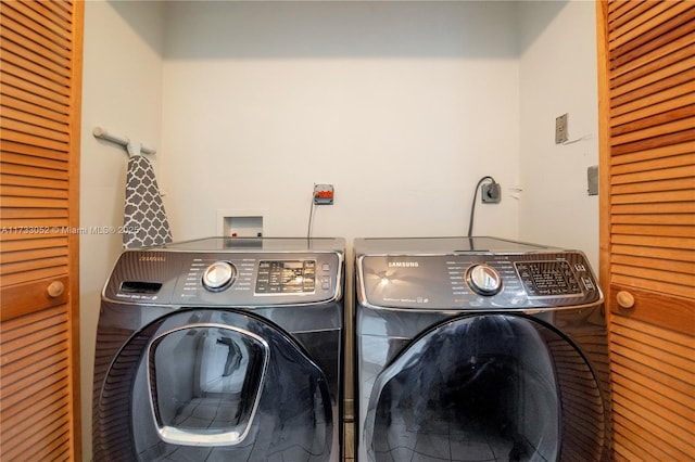 clothes washing area featuring washing machine and dryer