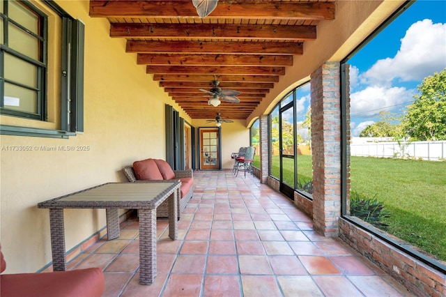 unfurnished sunroom featuring beamed ceiling and wood ceiling