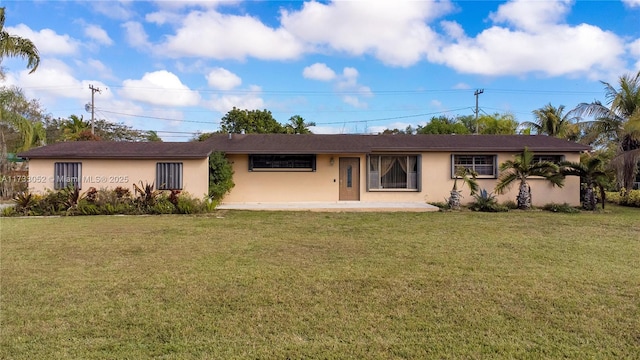 view of front facade with a patio and a front lawn