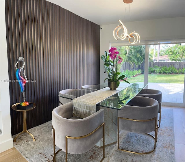 dining room with an inviting chandelier and light hardwood / wood-style flooring