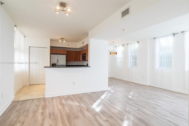 unfurnished living room with light hardwood / wood-style flooring