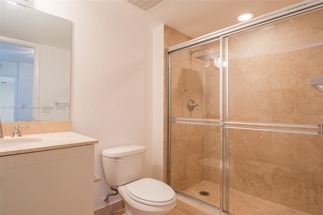 bathroom featuring vanity, toilet, and an enclosed shower